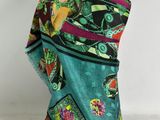 a close up of a colorful scarf on a mannequin head