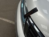 a sticker on the hood of a white car