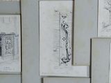 several sketches of architectural drawings on a wall in a room