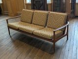 a couch that is sitting on a hard wood floor