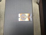 an image of a close up of a metal grill with a sign on it
