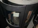 a black stove sitting in a room next to other stoves
