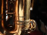a close up of a saxophone that is shiny gold