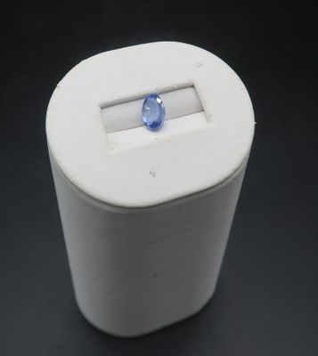 a white box with a blue stone inside of it