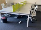 a room with a desk, chairs, and a computer on it