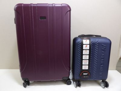 two pieces of luggage sitting next to each other on a table