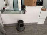 a black trash can in the middle of a kitchen