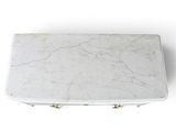 white marble table with brass legs and a white marble top
