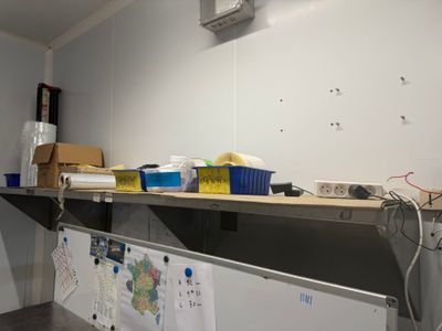 a metal shelf that has a bunch of papers on it