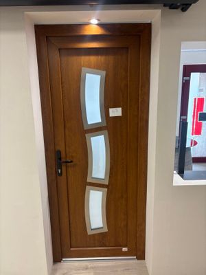 a wooden door with a glass window in a room