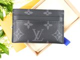 a close up of a wallet on a table next to a plant