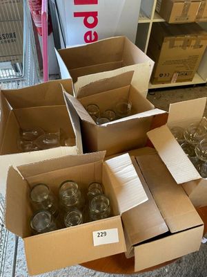 plusieurs cartons remplis de verres à vin vides posés sur une table