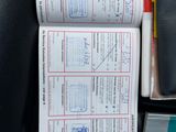 a lot of papers that are sitting on the seat of a car