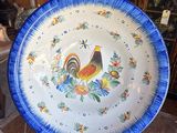 a blue and white plate with a rooster on it