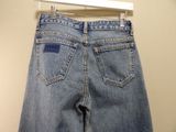 jeans hanging on a hanger on a wall in a room