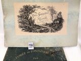un vieux livre posé sur une table, à côté d'une photo représentant une forêt