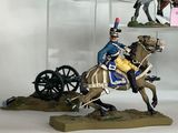 four figurines of people riding horses and a man on a horse drawn carriage