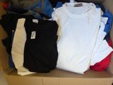 a box full of clothes that is sitting on the floor