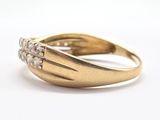 an image of a close up of a gold ring with diamonds on it