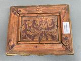 an old wooden picture frame with a floral design on it