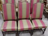 four chairs with striped upholstered seats are sitting on a tile floor
