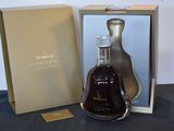 a bottle of liquor sitting in a box on a table