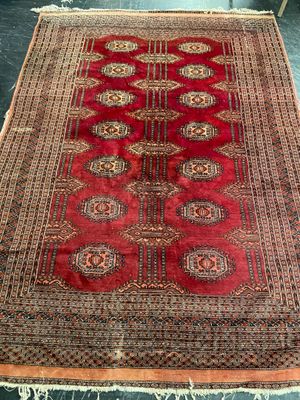 an oriental rug with a red and brown design on it