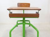 a green desk and a brown chair in a room