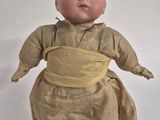 a small doll that is sitting on a table