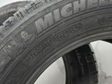 tires are lined up on a white surface in a room