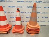 three orange and white traffic cones sitting on top of a table