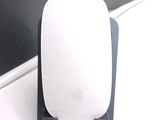 a white apple mouse sitting on top of a desk