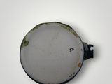a white plate with a black handle on a white surface