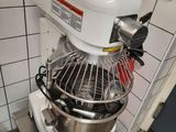 a mixer that is sitting on a stand in a kitchen