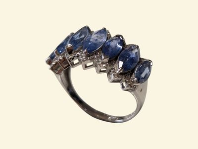 an image of a blue sapphire and diamond ring on a white background