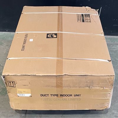 a large cardboard box sitting on the floor in front of a black wall