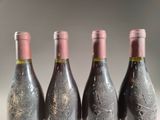 three bottles of wine are lined up on a table