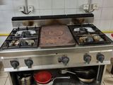 a kitchen with a stove and a pot on the counter