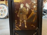 an image of a clock with a painting on it in a room