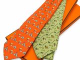 three ties are stacked on top of each other on a white surface