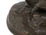 a statue of a bird on a plate with a bird on it