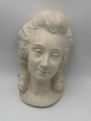 a statue of a woman that is on a table