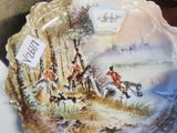 a plate with a picture of a man riding a horse on it