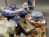 a lot of blue and white dishes and cups on the table