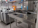 a large kitchen with stainless steel counter tops and a sink