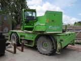 a large green truck that is parked in a lot