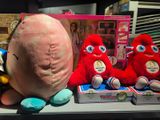 several stuffed animals are sitting on a shelf next to books