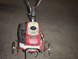 a small lawn mower that is sitting on the ground