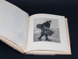 an open book with a picture of a man carrying a bag