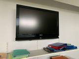 a flat screen tv mounted on a wall in a room